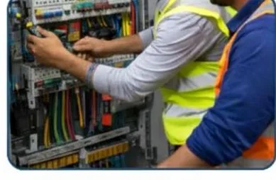 Technician working inside an electrical panel
